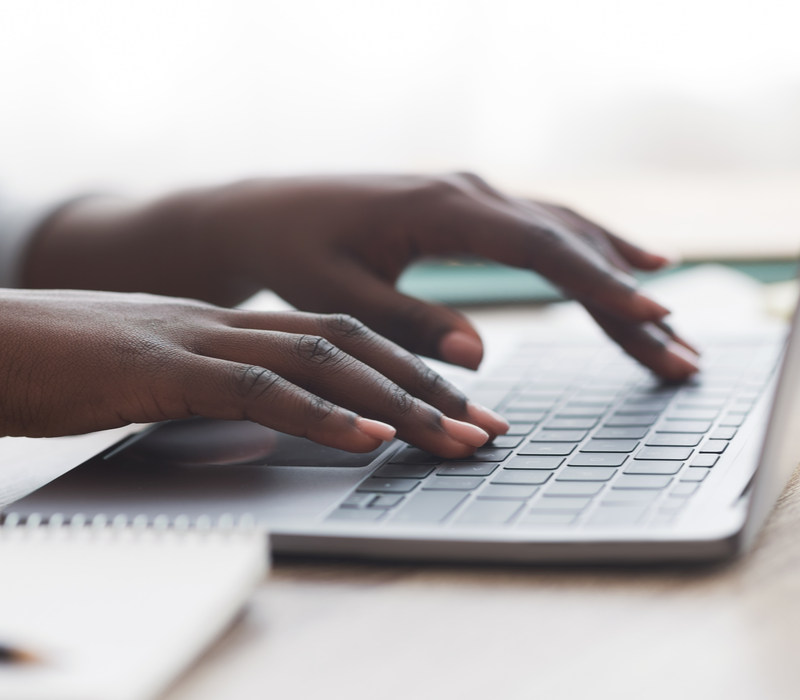 A person typing on a laptop