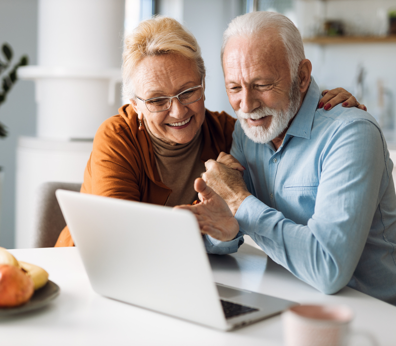 An older couple using a laptop.