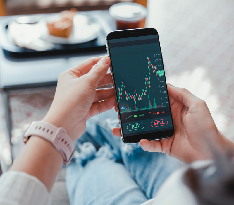 A woman looking at investment performance on a phone.