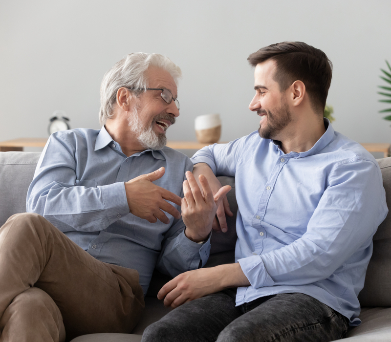 Father and adult son talking.