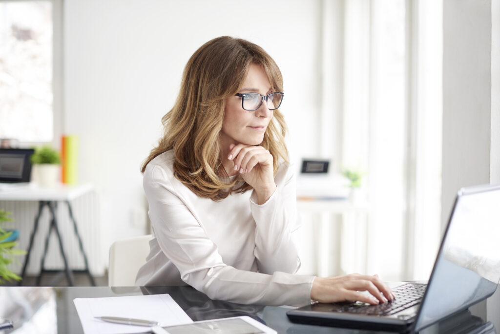 A businesswoman working on a computer.
