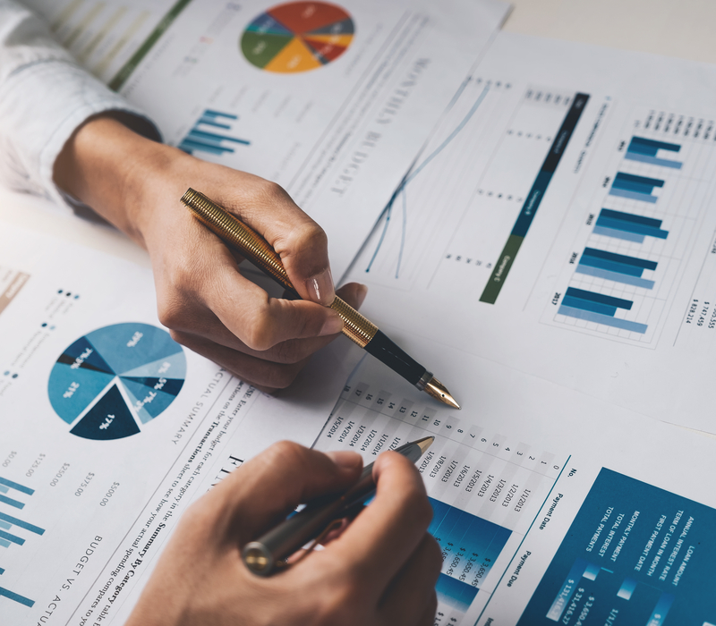 Two people looking at financial documents.