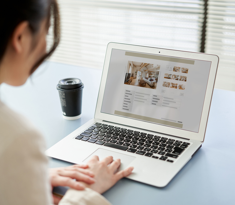 A woman looking at a property listing online.