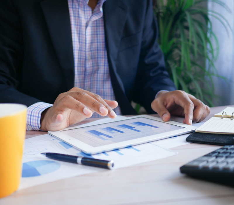 Business man looking at charts on a tablet.