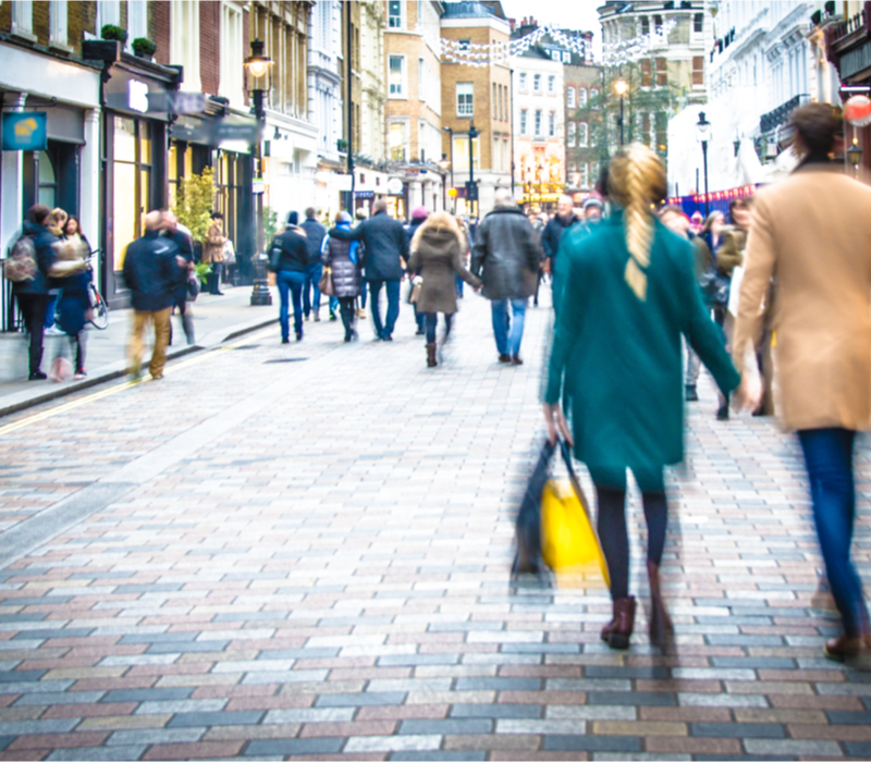 Shoppers walking down a high street.