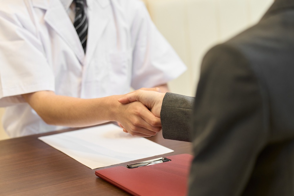 Two people shaking hands.